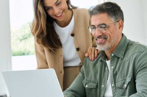 Casal mexendo no computador realizando uma compra segura
