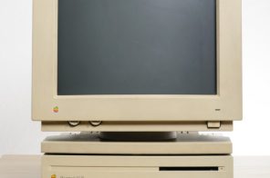 Macintosh sobre uma mesa de trabalho, simbolizando a invenção dos primeiros computadores de uso pessoal.