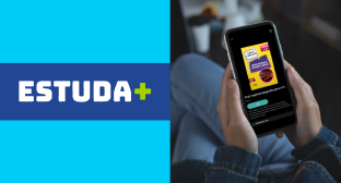 Banner com mãos segurando um celular à direita, exibindo o app “Estuda+”, e, à esquerda, em fundo azul, o logo “Estuda+”, indicando o app parceiro da Desktop Internet.